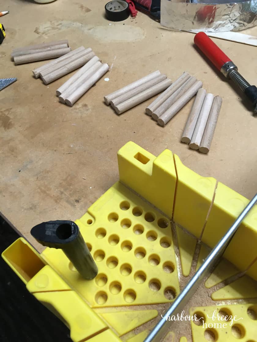 Dowels lined up and ready to be used for this DIY floating shelf with dowels.