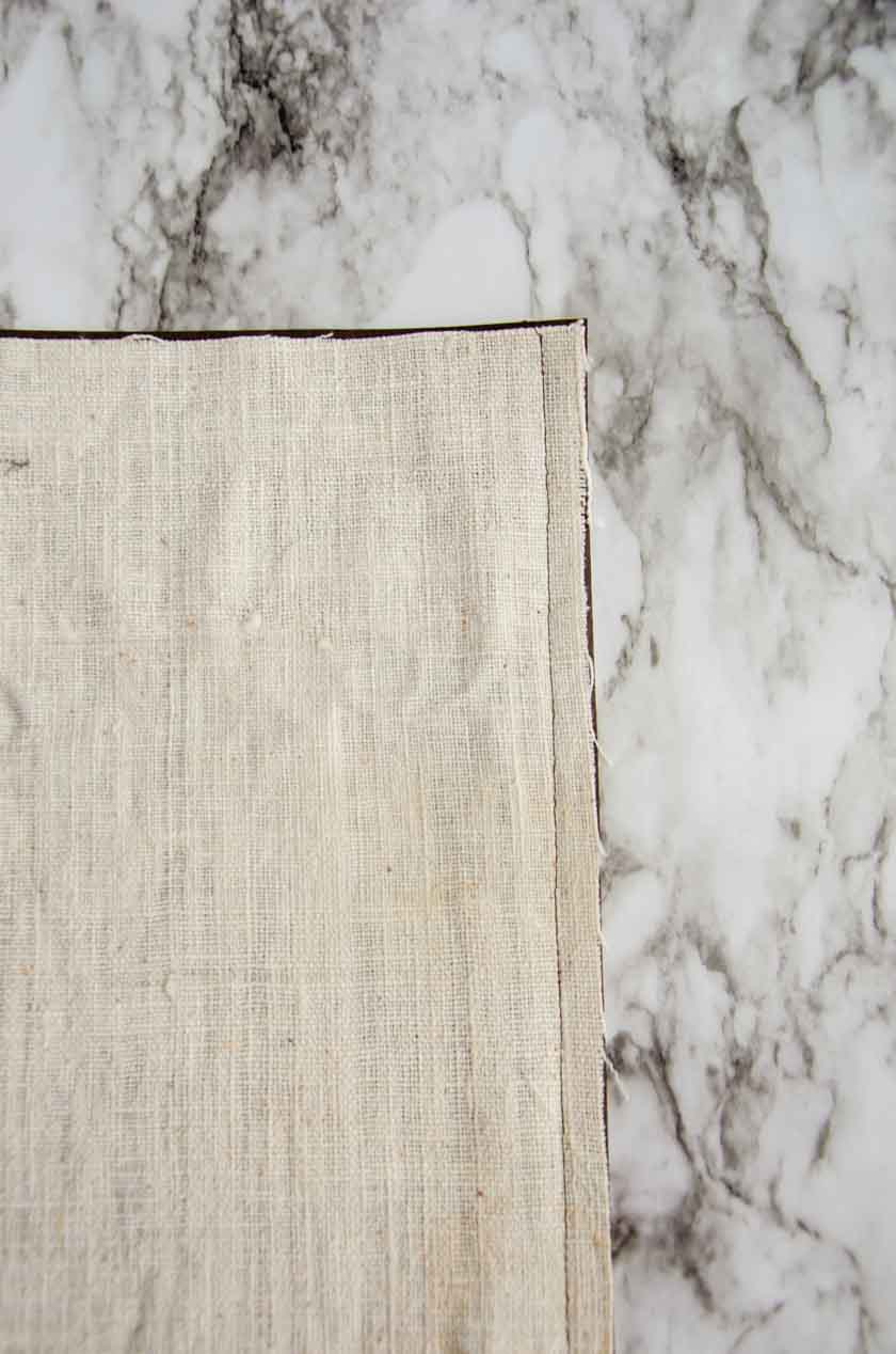 The bottom seam in a faux leather pillow cover.