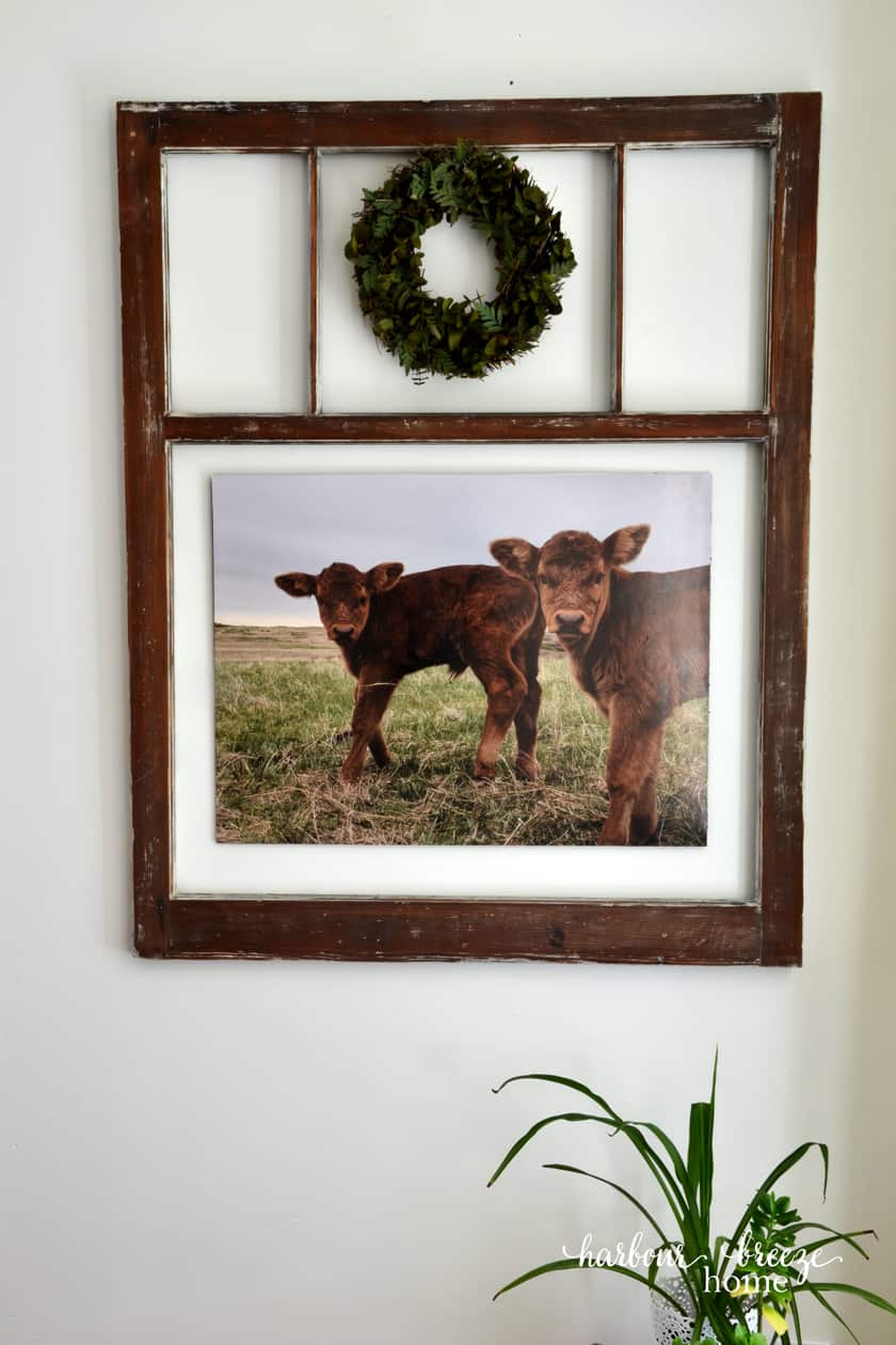 Large photo mounted on foam board hung on the wall.