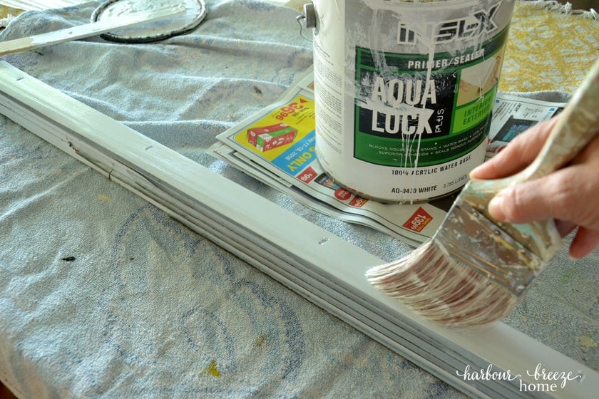 applying paint primer with a brush