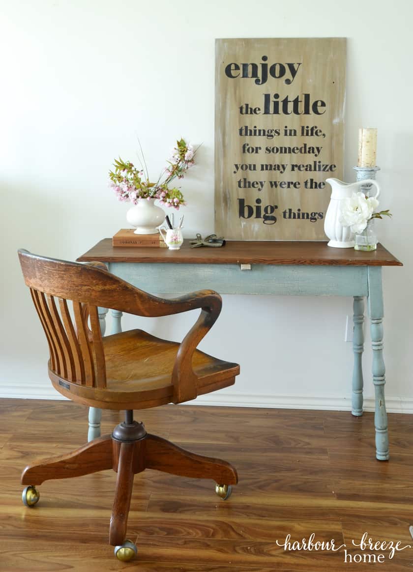 picture of farmhouse table with antique oak office chair sitting in front