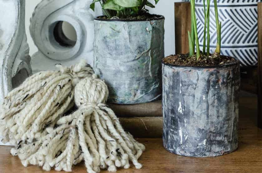 Finished DIY flower pots out of tin cans that look like cement.
