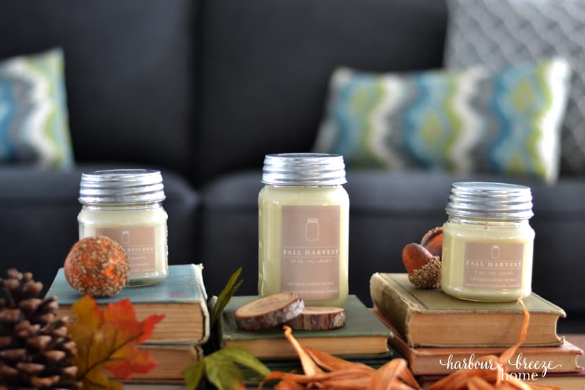 3 candles from Antique Candle Works sitting on stacks of antique books