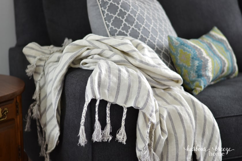striped linen blanket draped over the arm of a couch
