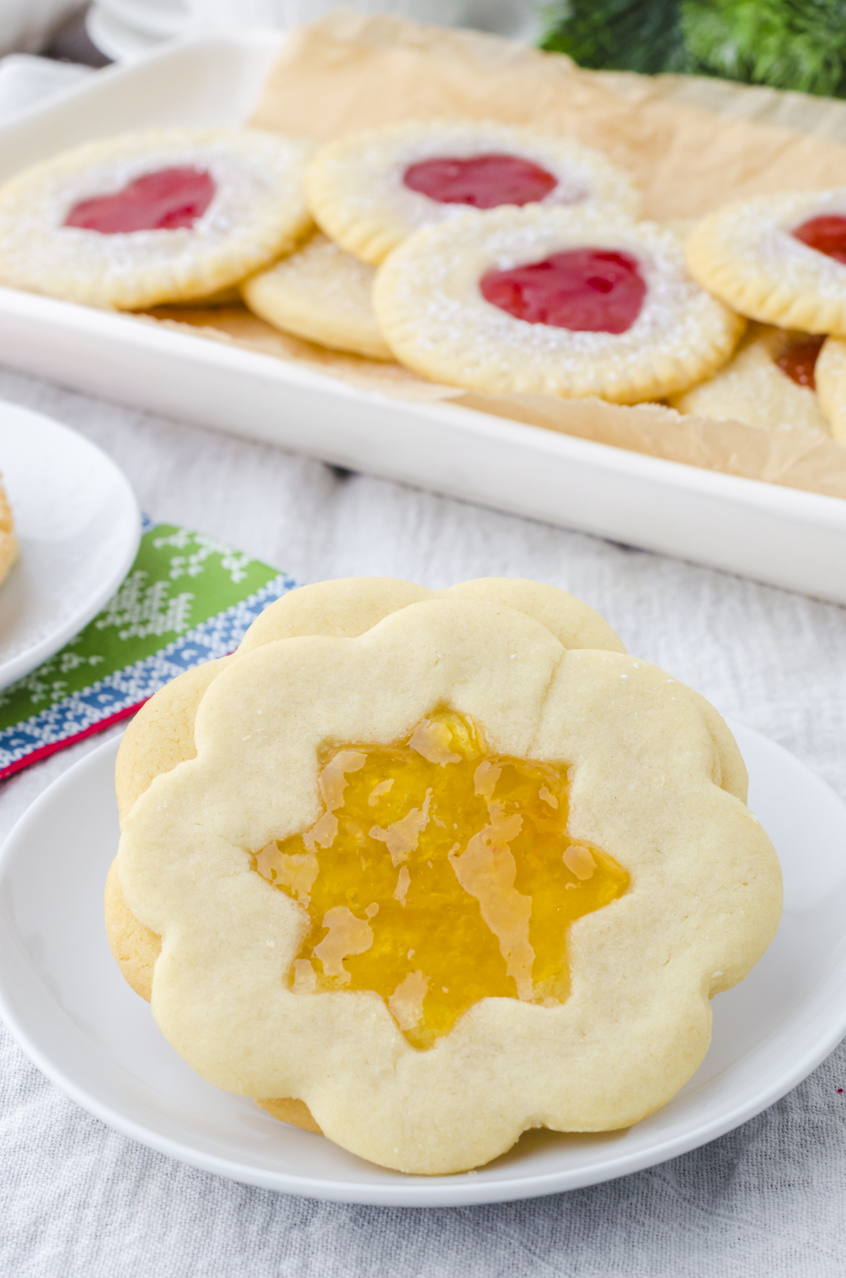 Jam sandwich cookies with star cutout and peach jam.