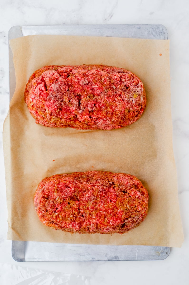 2 meatloaves frozen on a cookie sheet lined with parchment paper