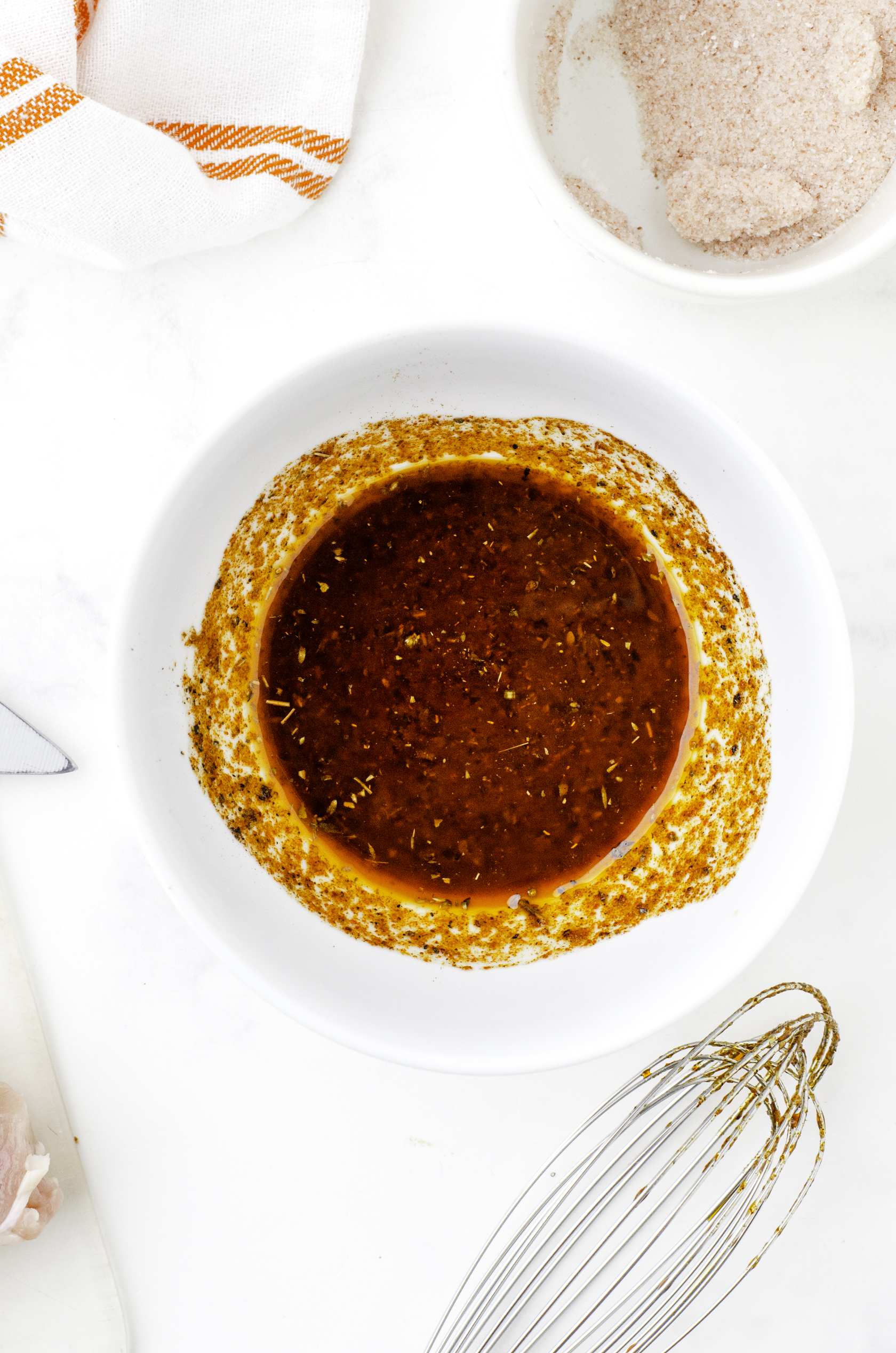 Mexican chicken marinade ingredients stirred together in a bowl.