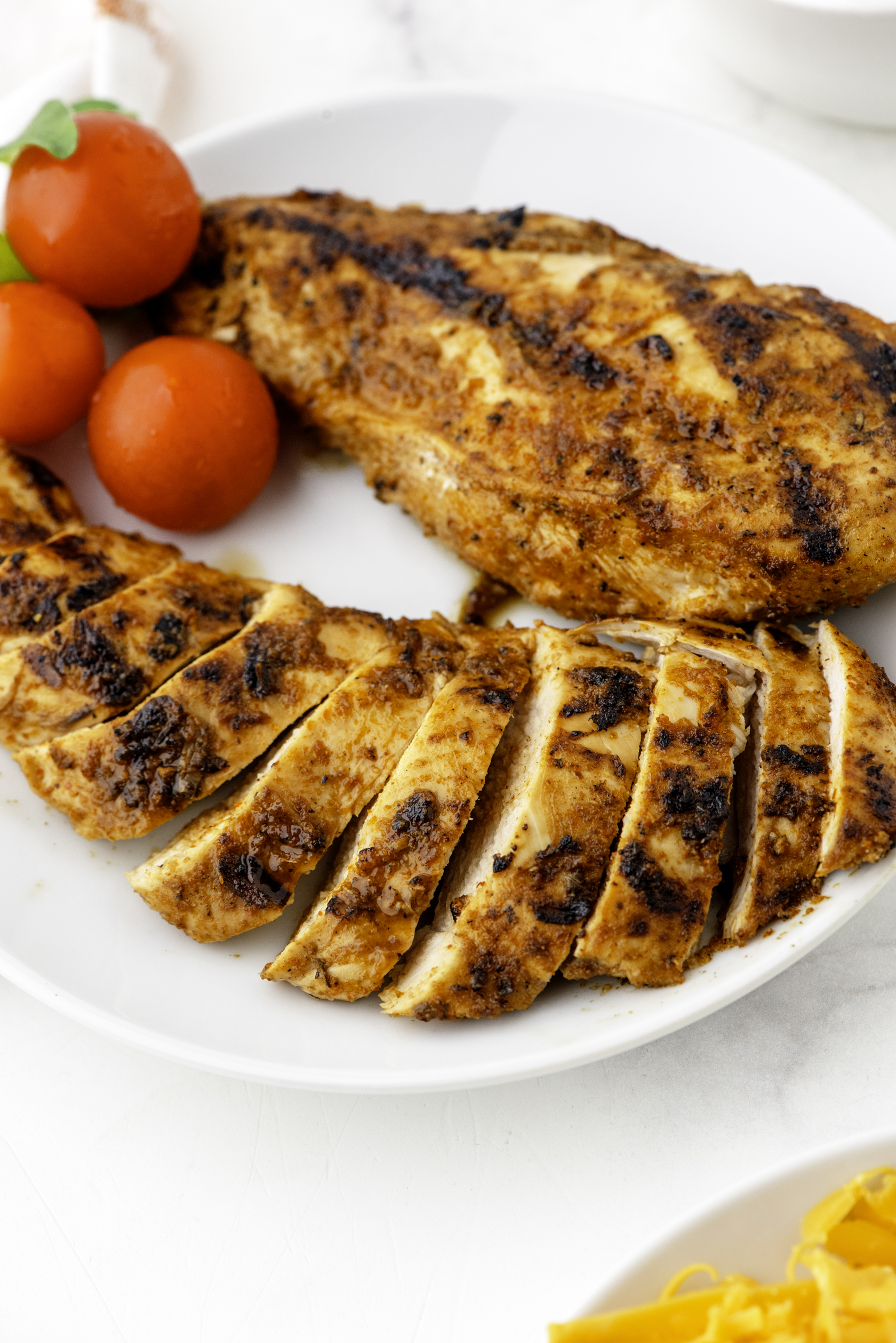 A plate of cooked, sliced Mexican chicken breasts.