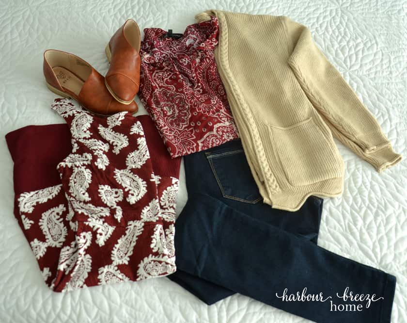 Clothes laid out on white background ~ a dress, leather flat shoes, jeans, blouse, and cardigan