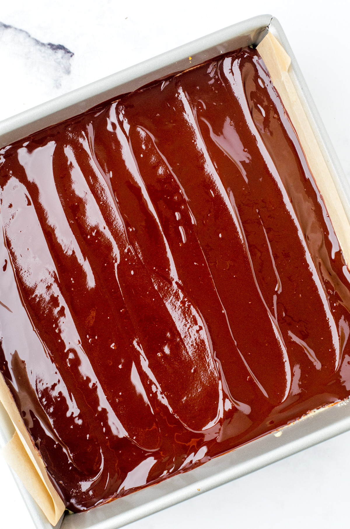Chocolate spread on top of nanaimo bar layers