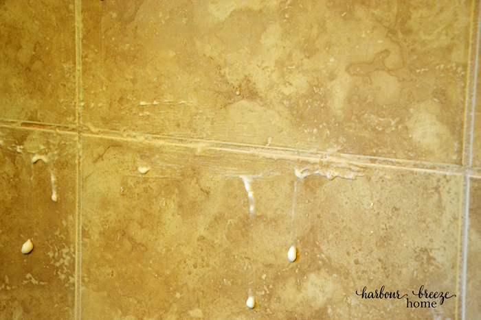cleaning shower tiles grout with a paste of baking soda and hydrogen peroxide