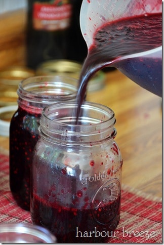 blackberry jam being poured into jars