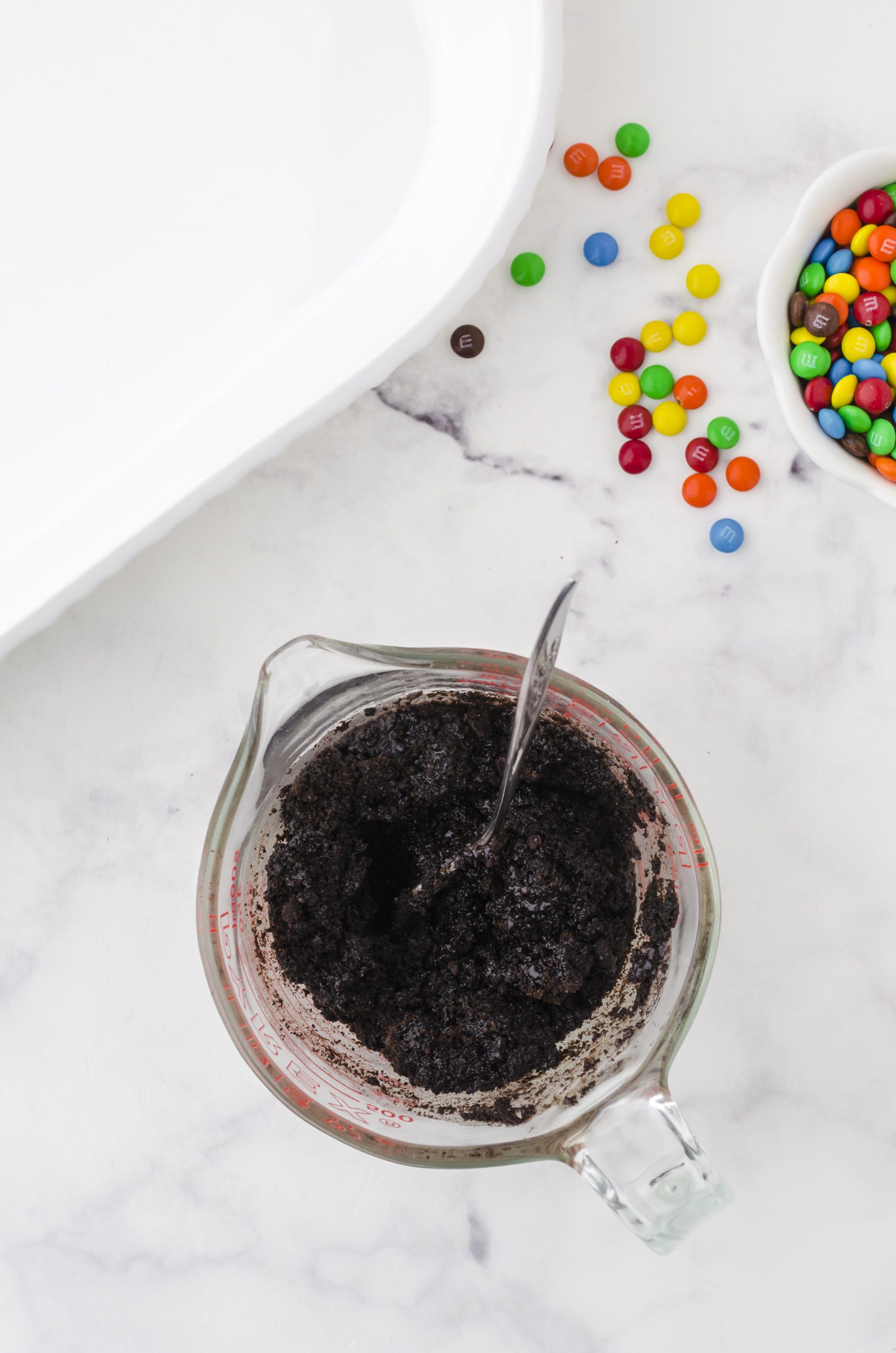 ingredients for oreo crust mixed in a large measuring cup