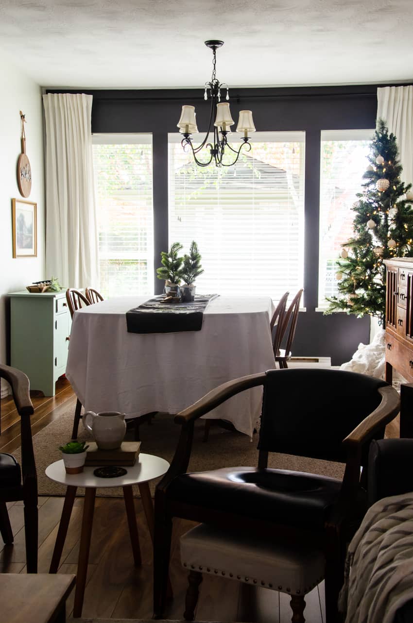 a Dining Room with a dark gray painted accent wall
