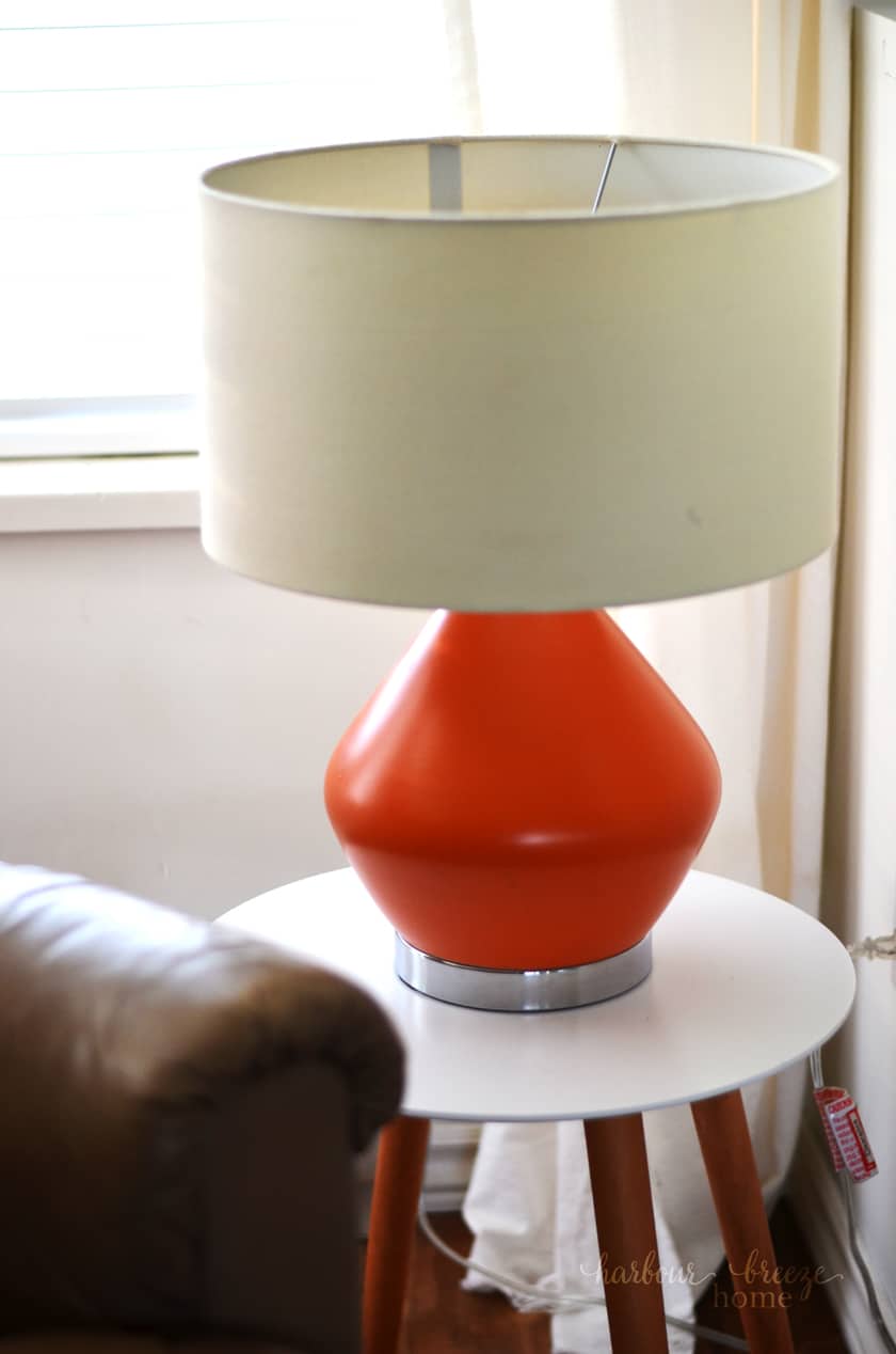 Orange Table lamp sitting on a living room end table