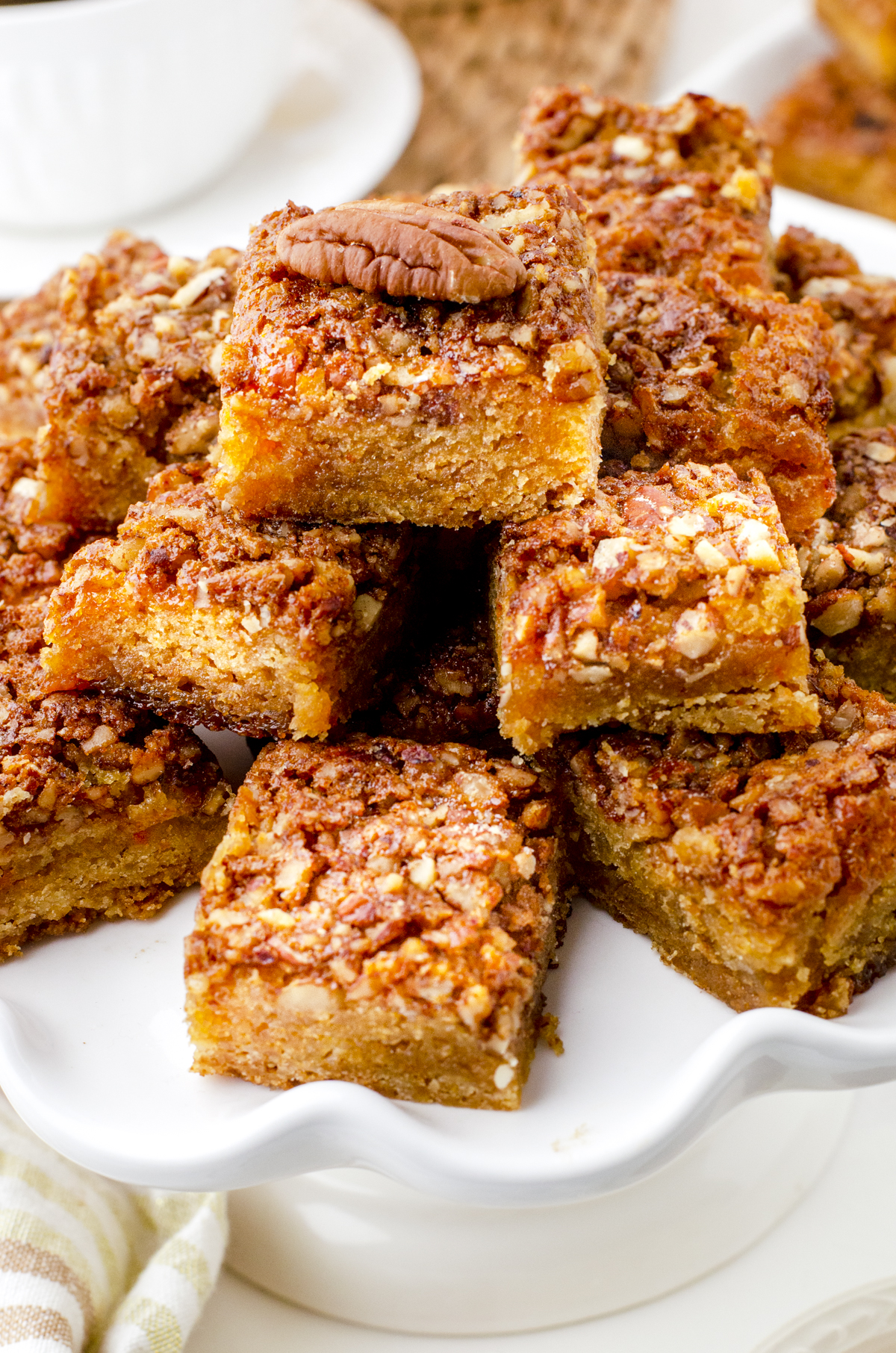 a platter of stacked pecan pie bar squares