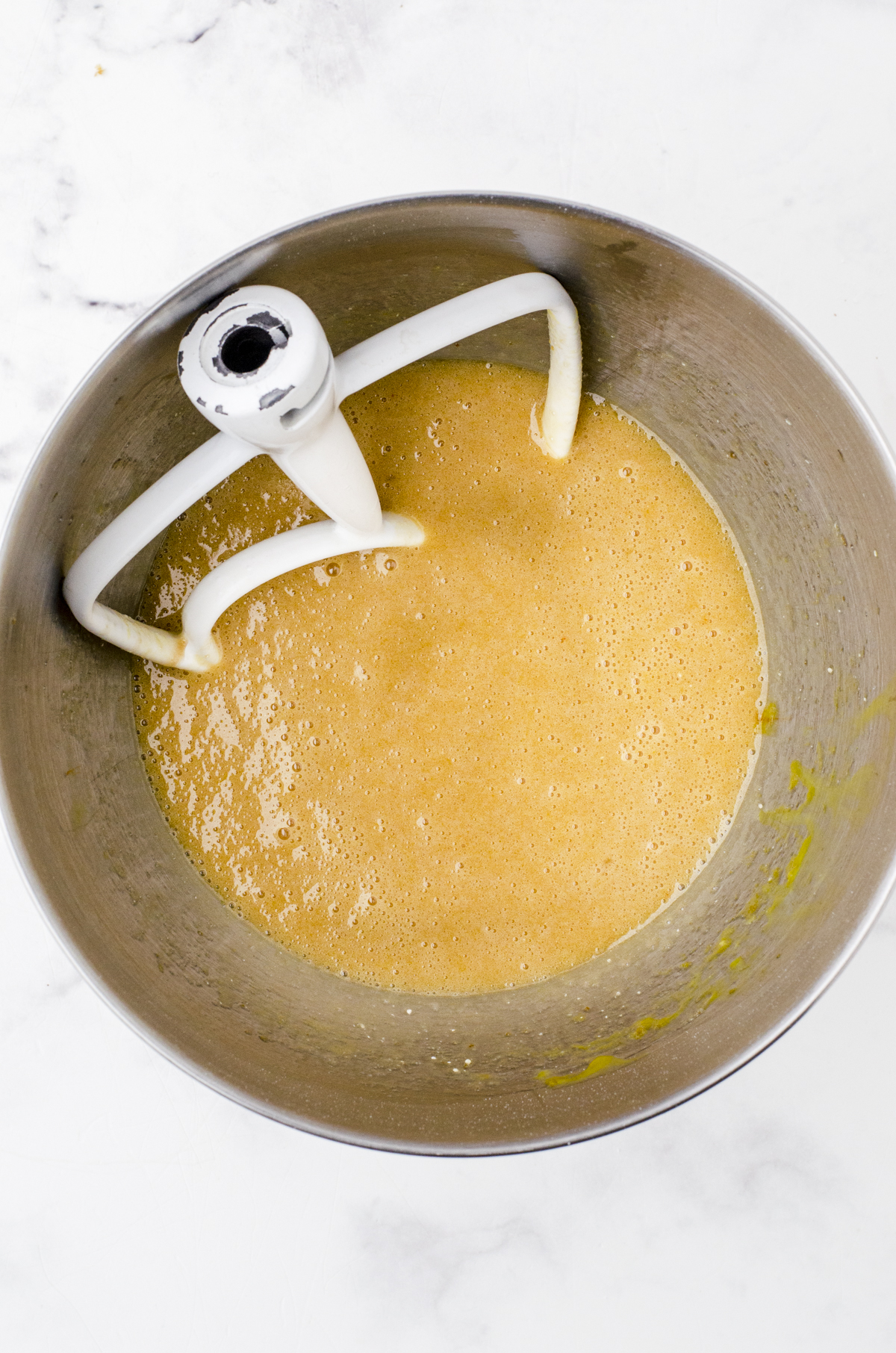 Pecan pie bar filling being mixed in the bowl of a stand mixer.