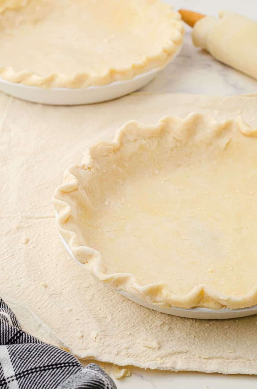 Two homemade pie crusts ready to bake.