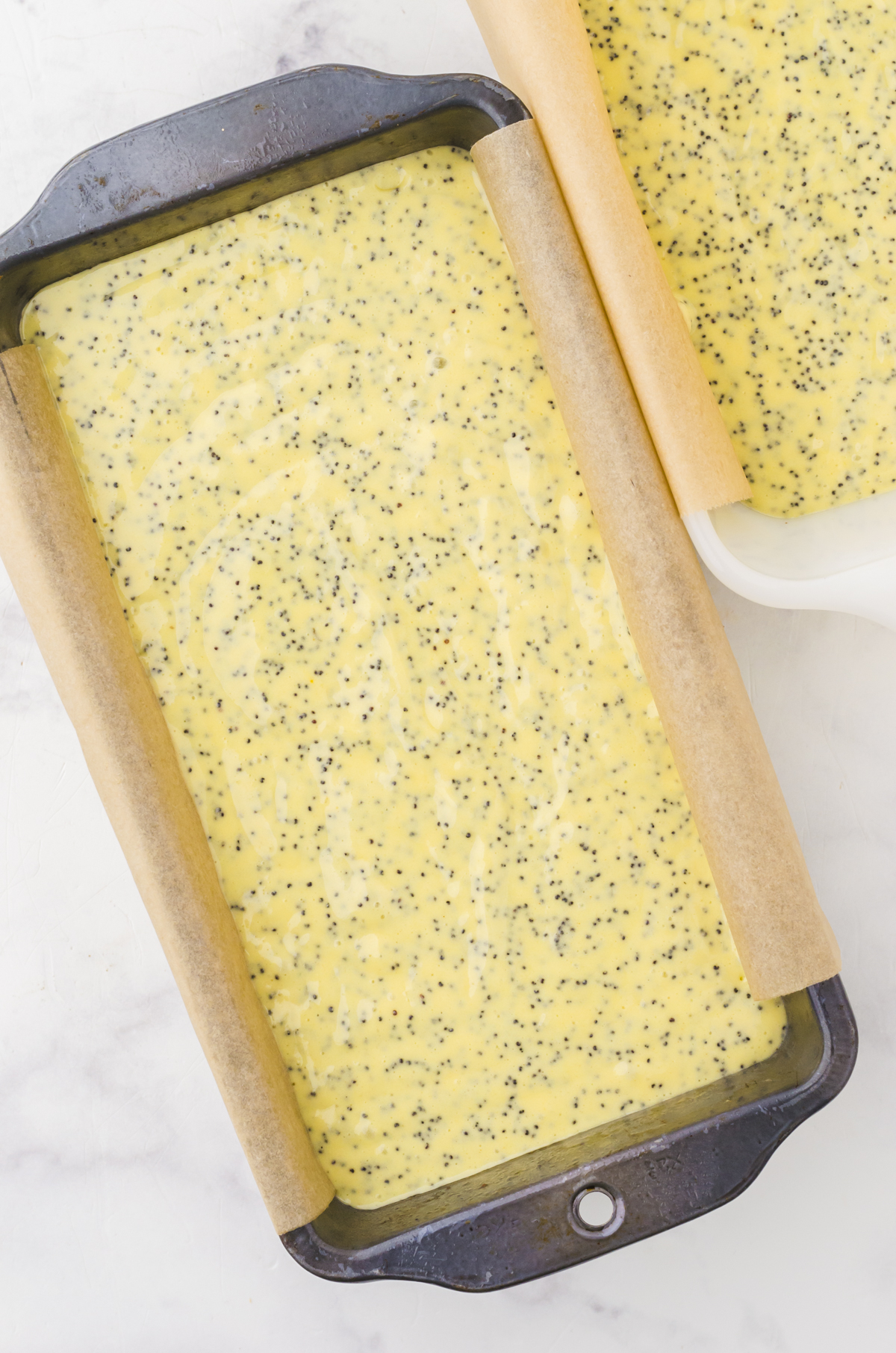 Poppy seed bread batter in loaf pans ready to bake.