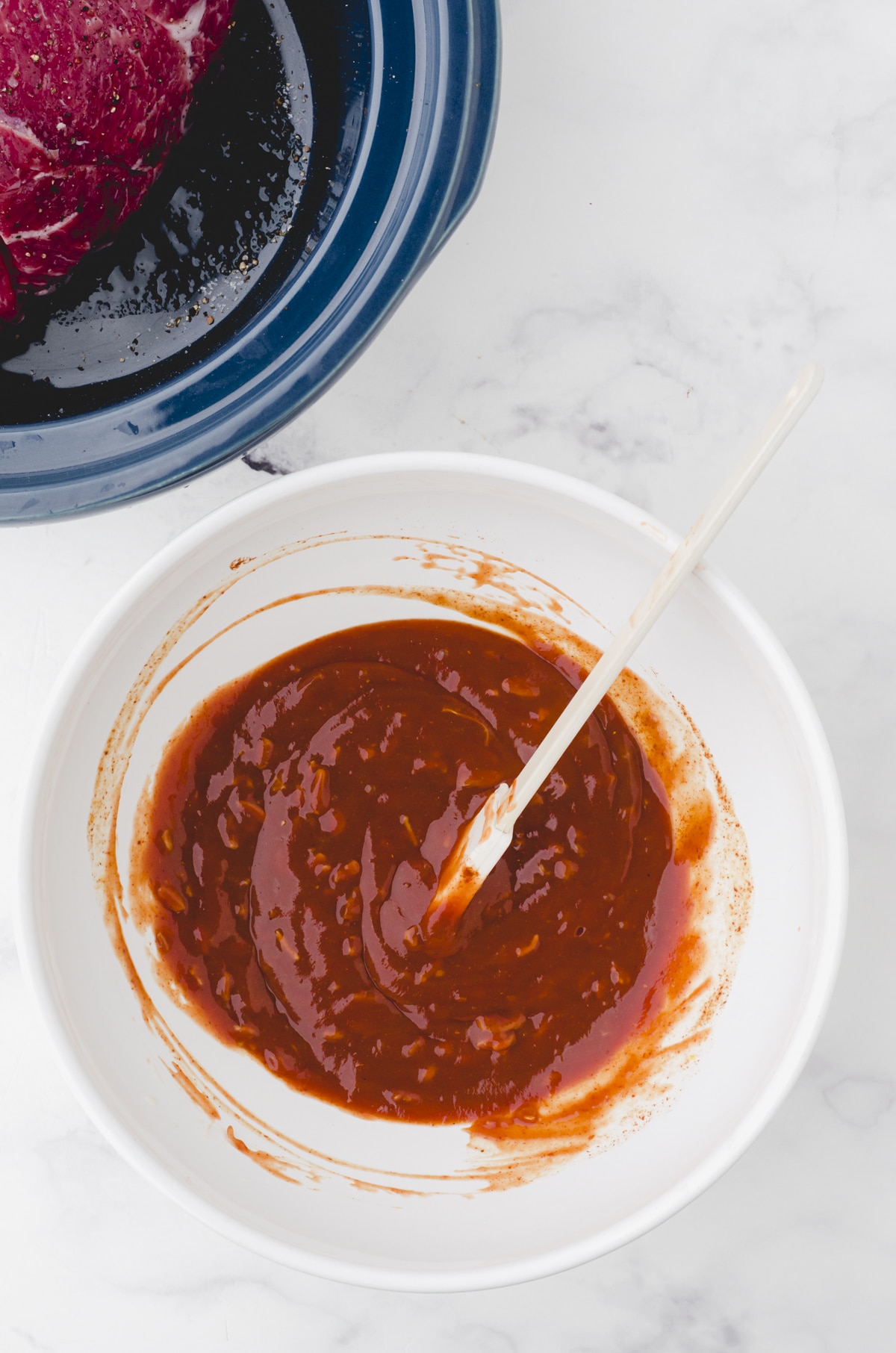 pulled pork recipe sauce being mixed in a mixing bowl