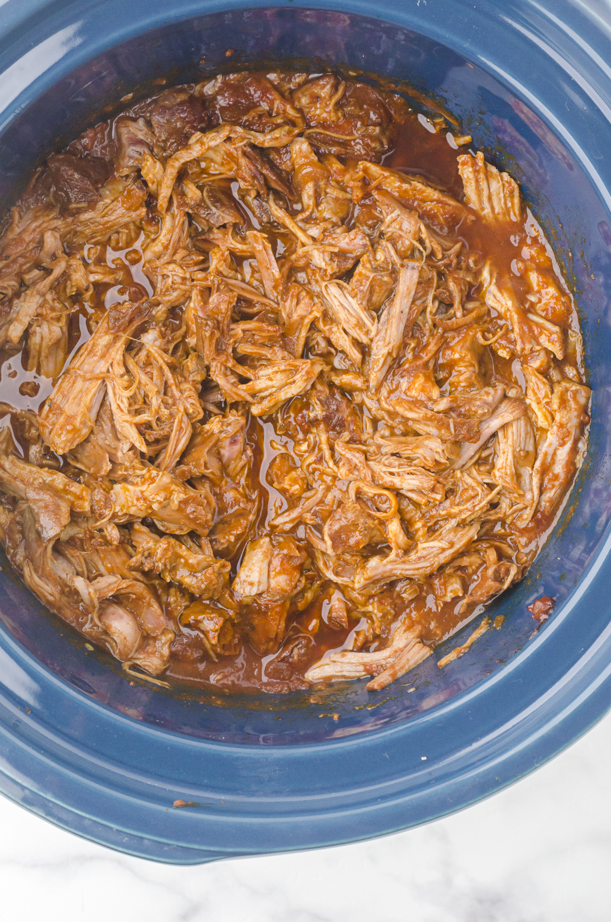 Shredded pulled pork added back into the crock pot for this pulled pork recipe.