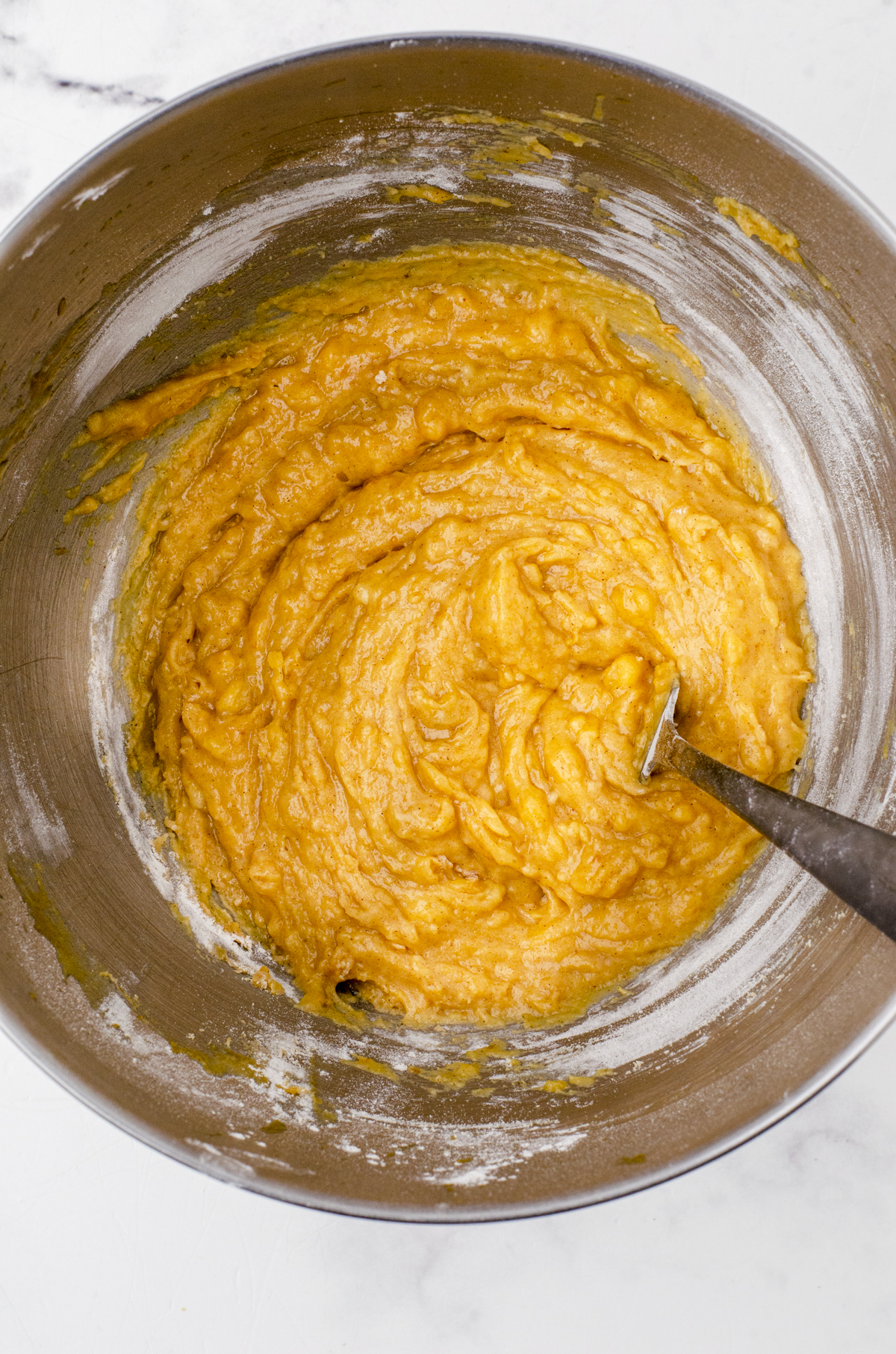 Pumpkin banana muffin batter in a bowl.