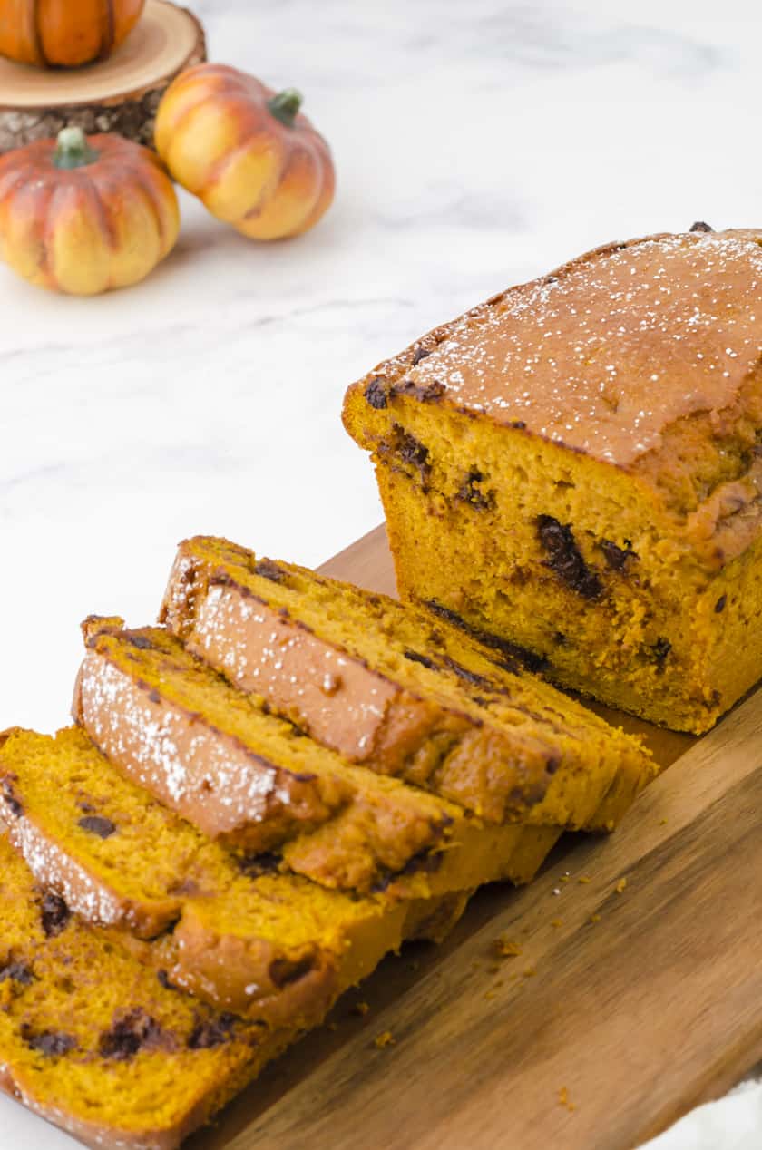 Close up of sliced chocolate chip pumpkin bread on a cutting board.