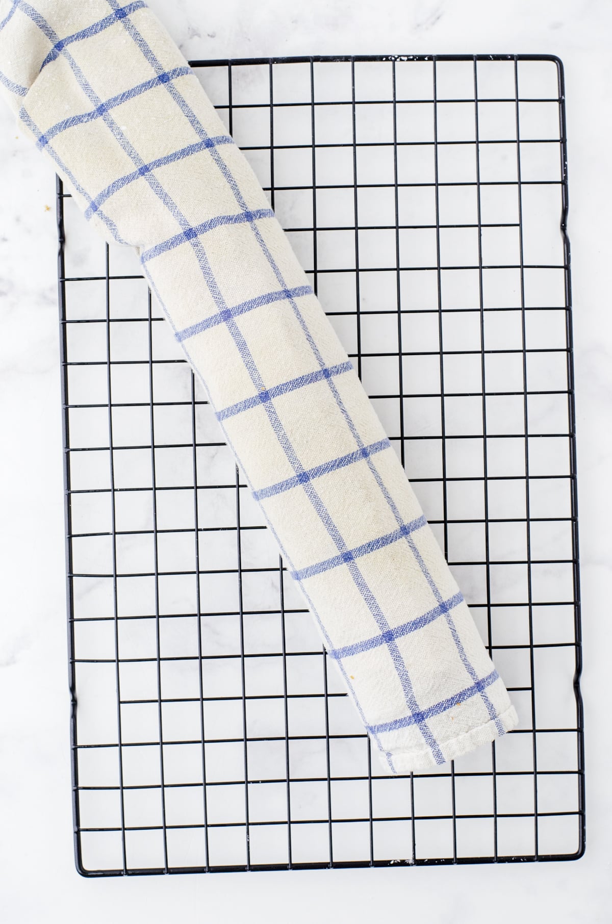 pumpkin cake rolled into a tea towel for pumpkin roll