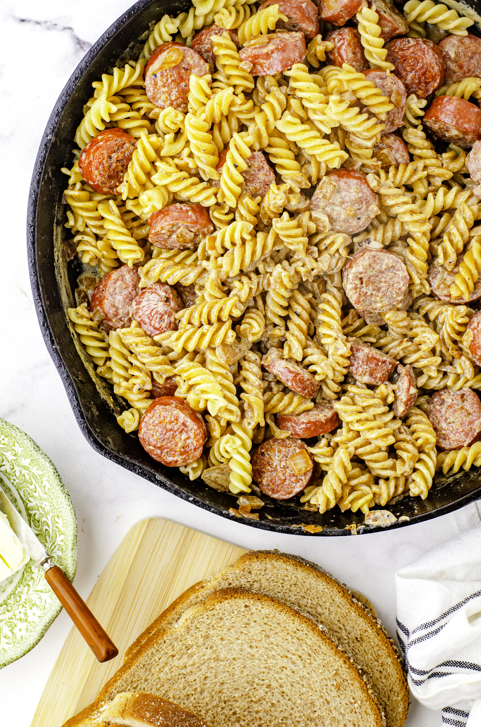 Farmer's sausage and noodles with cream gravy in a cast iron skillet