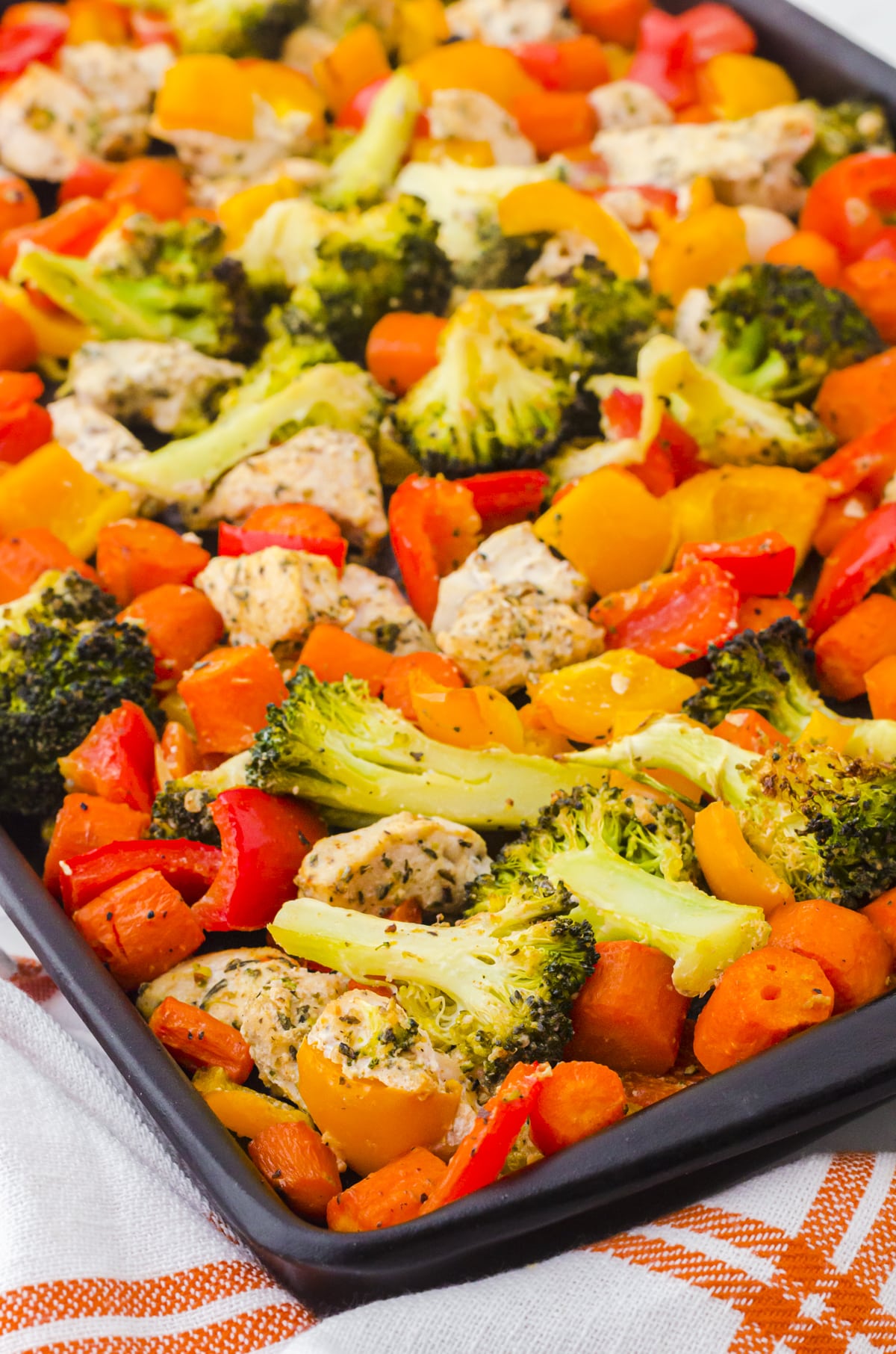 Chicken vegetable sheet pan dinner in a sheet pan.