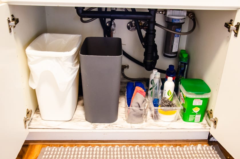 organized under sink cupboard with under cabinet mat