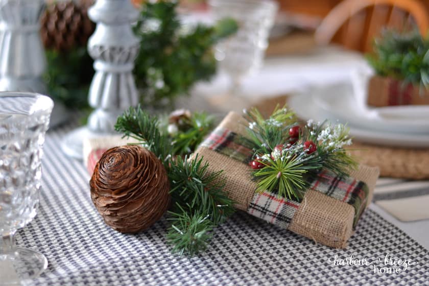 burlap wrapped gift centerpiece on a farmhouse christmas table setting