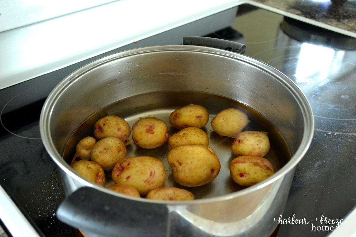 Baby potatoes in a big pot covered with water.