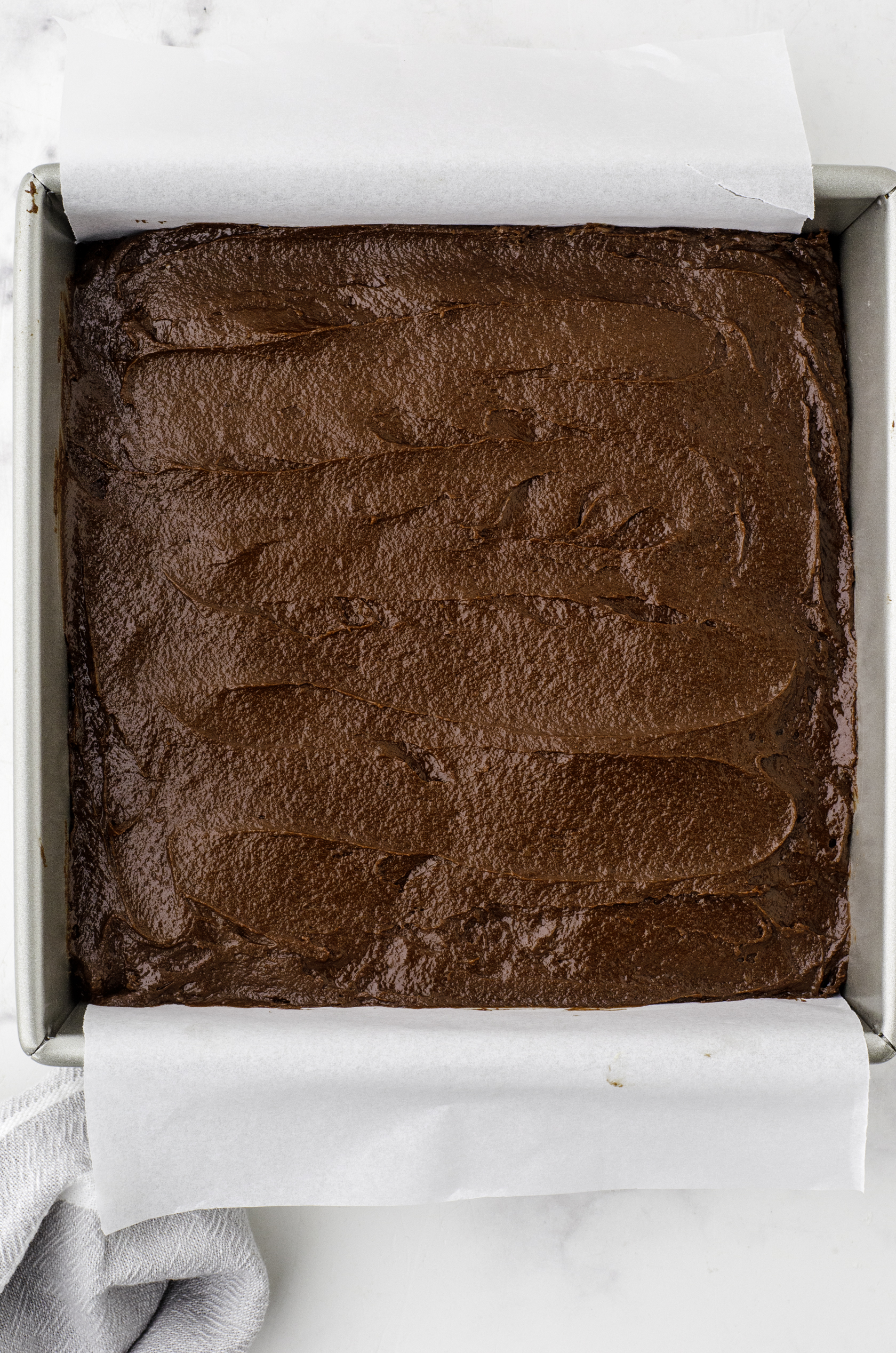 Sourdough chocolate brownies in the baking dish ready to be baked.
