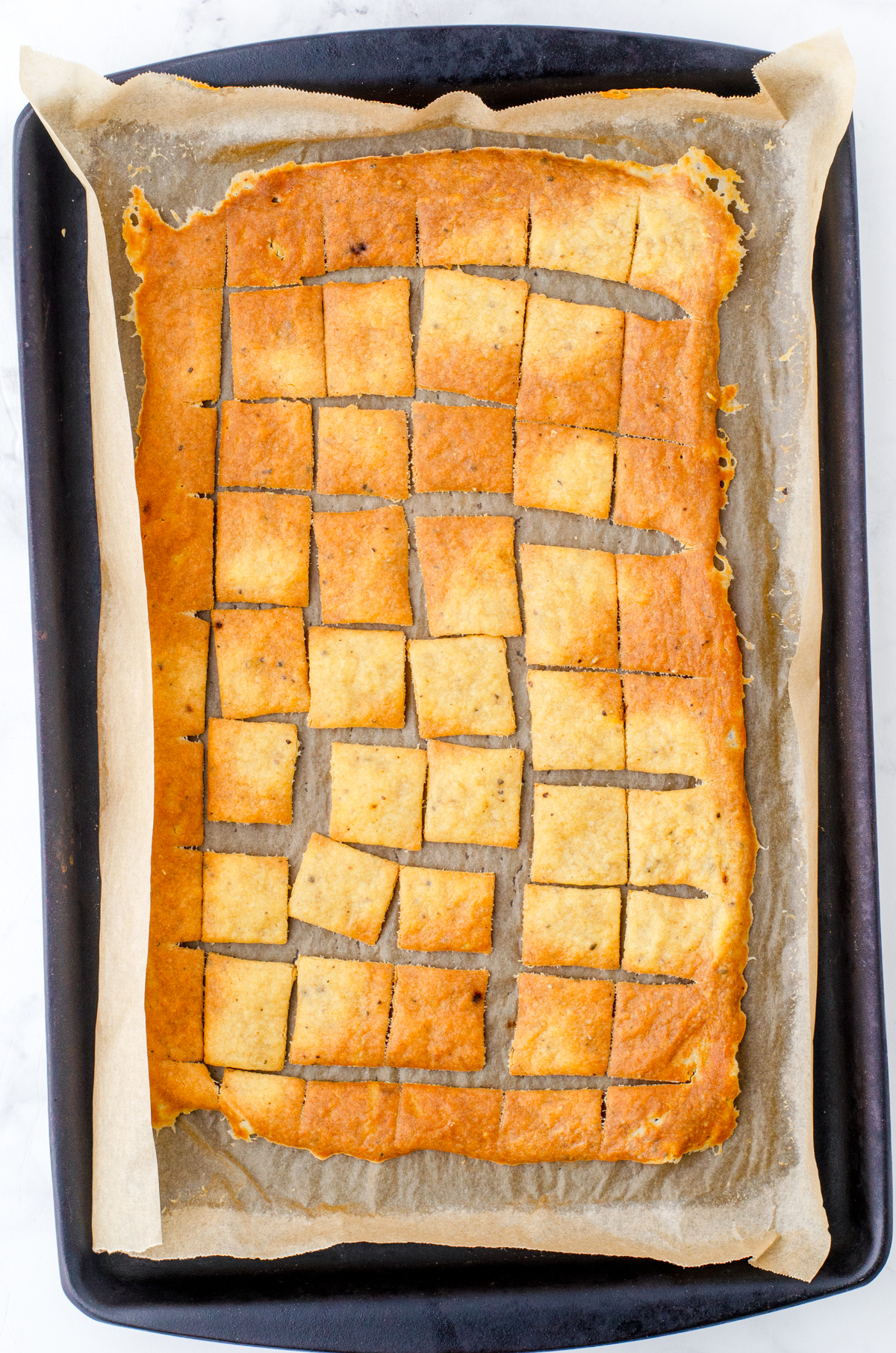 Baked sourdough chips that are browned and crispy.