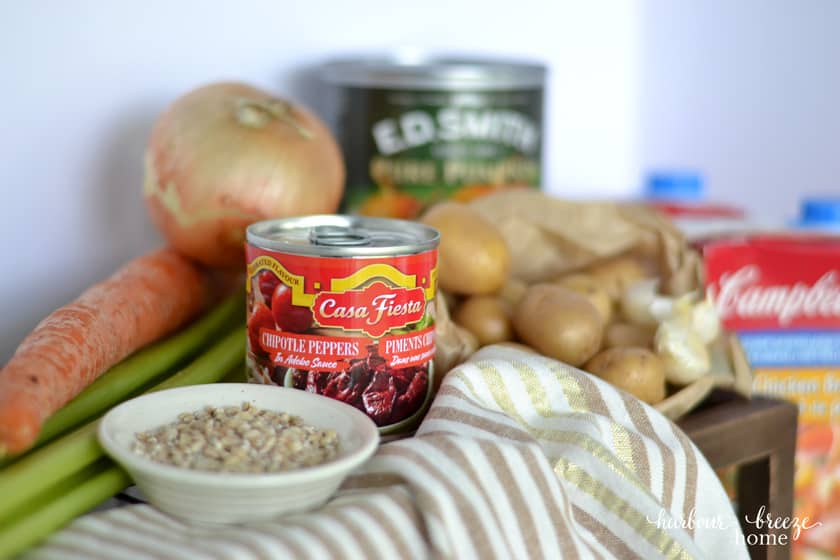 Soup ingredients with a focus on a can of chipolte peppers
