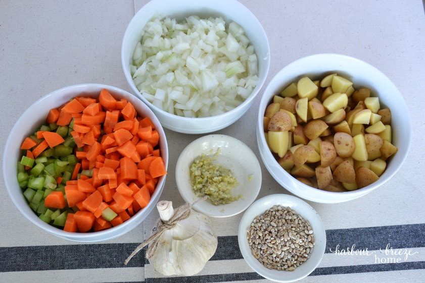 3 bowls filled with chopped vegetables ~ carrots & celery, onions, & diced potatotoes