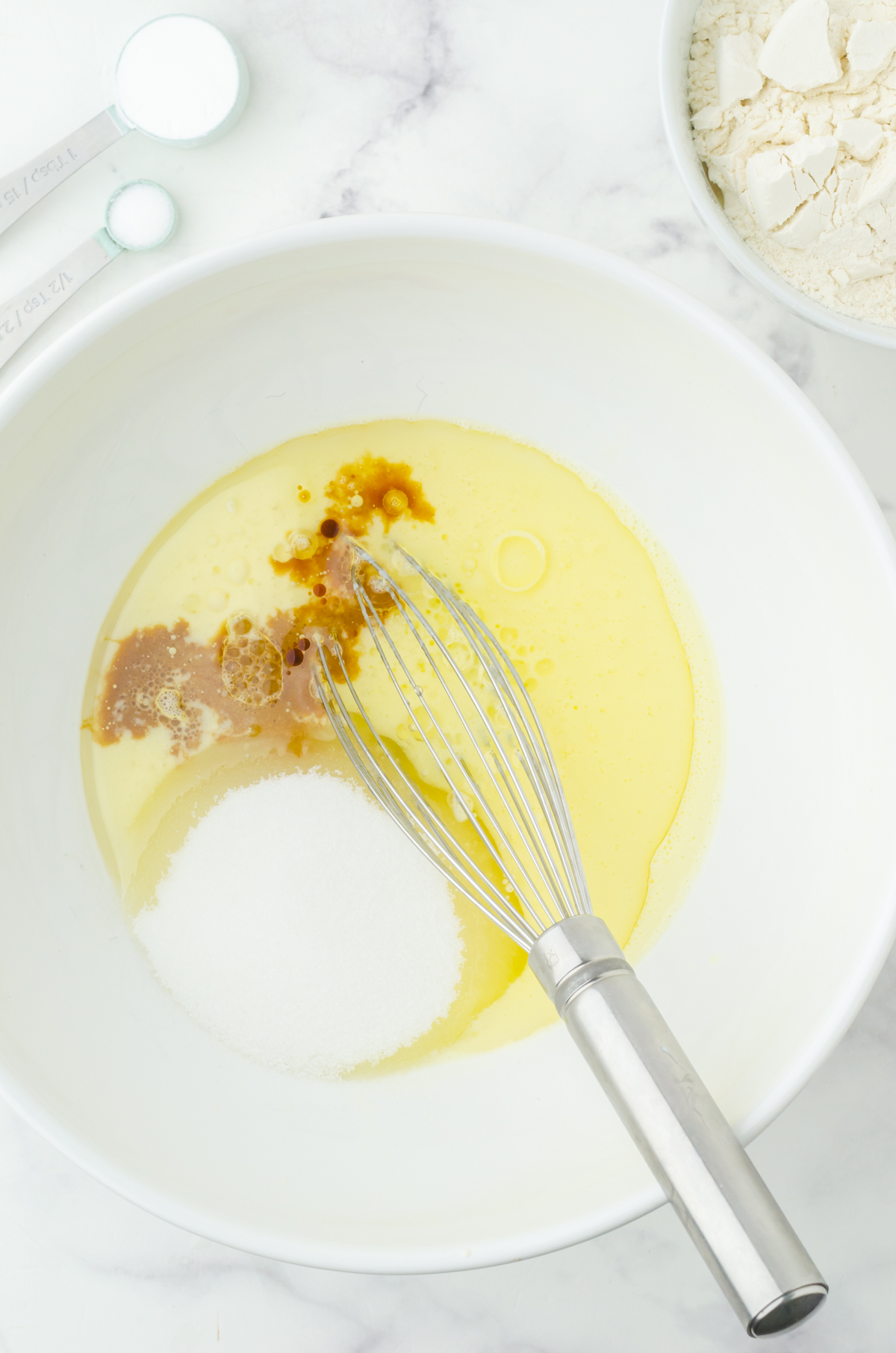 Egg, buttermilk, oil, sugar, and vanilla in a medium sized mixing bowl with a whisk.
