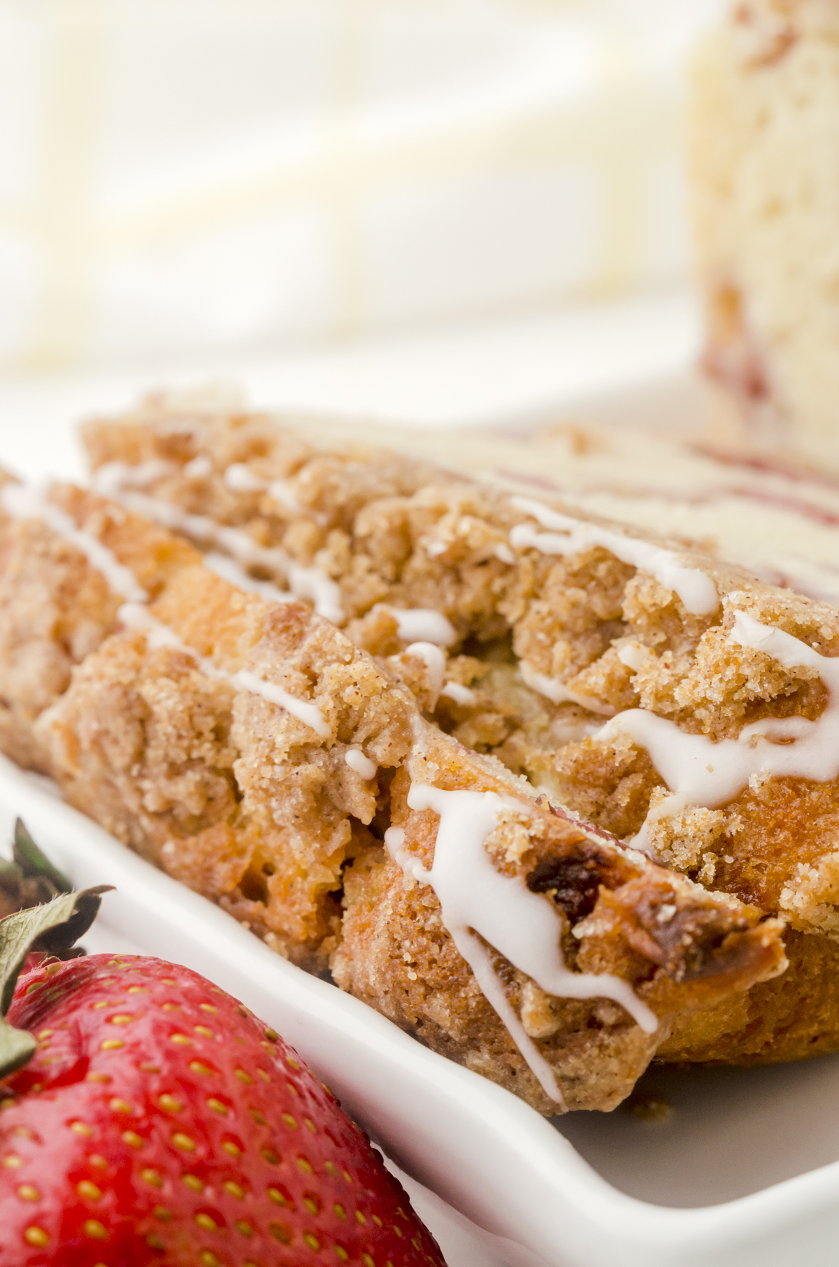 Slices of strawberry bread with a drizzle of vanilla glaze.
