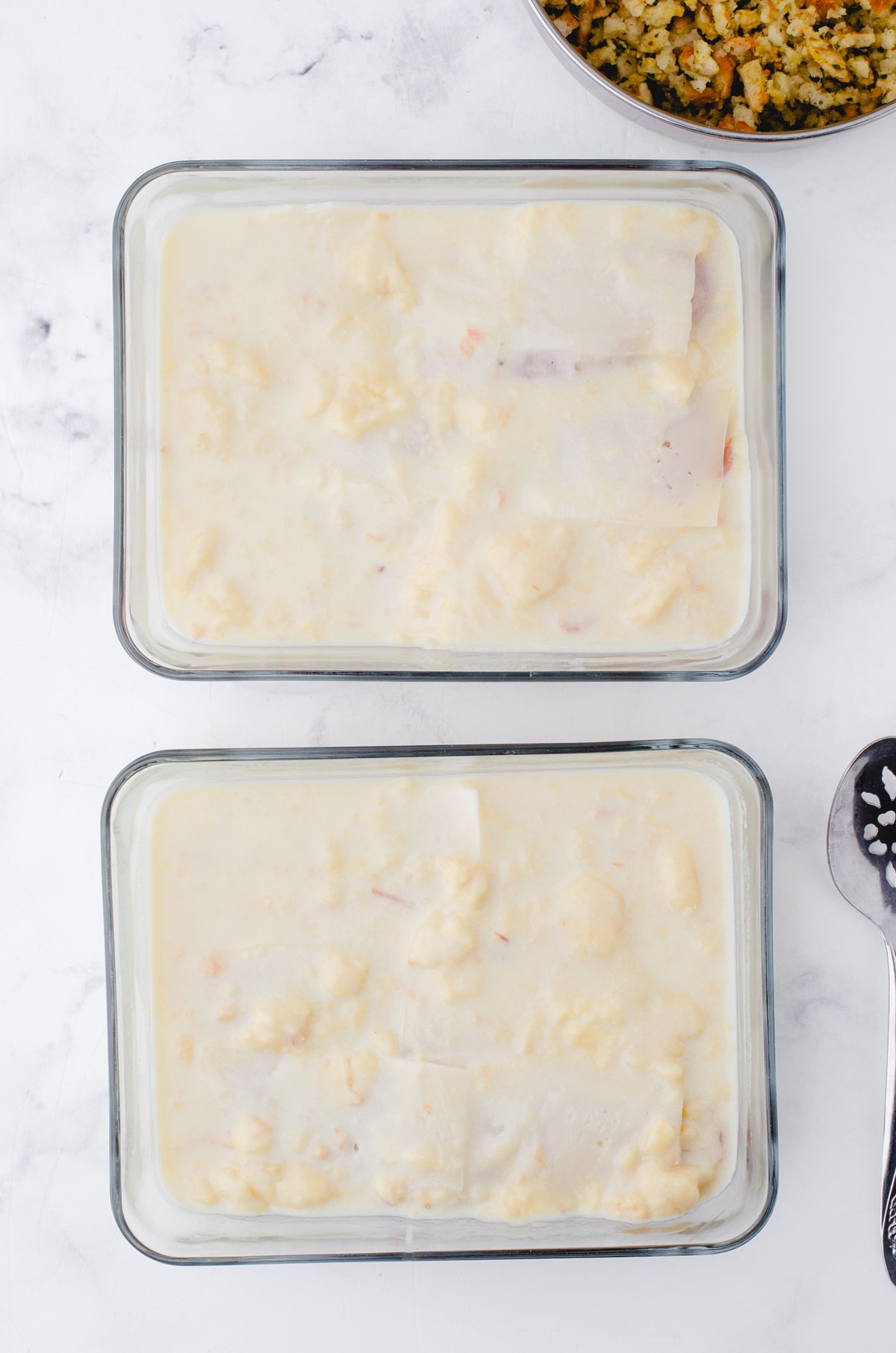 Soup and milk mixture poured over the chicken with swiss cheese on it.