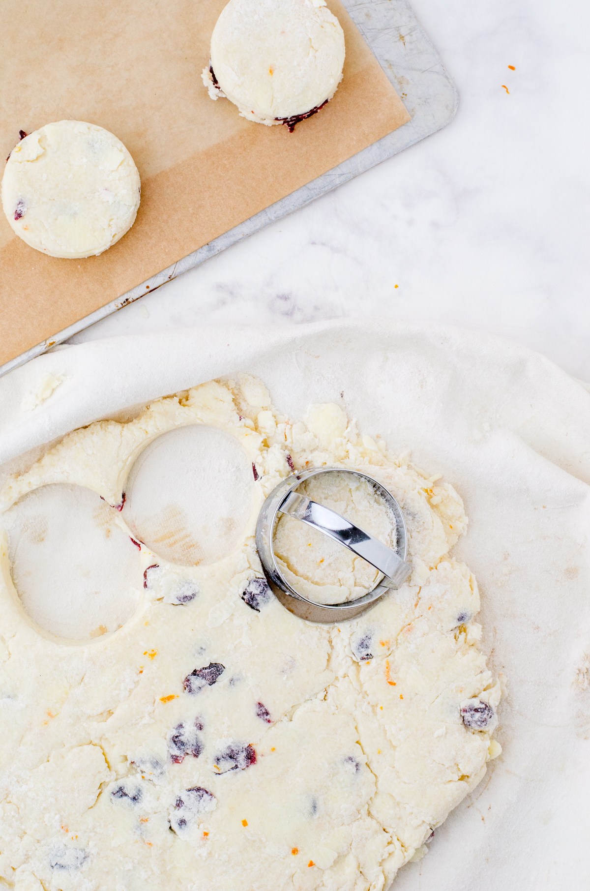Cream scones being cut with a round cutter