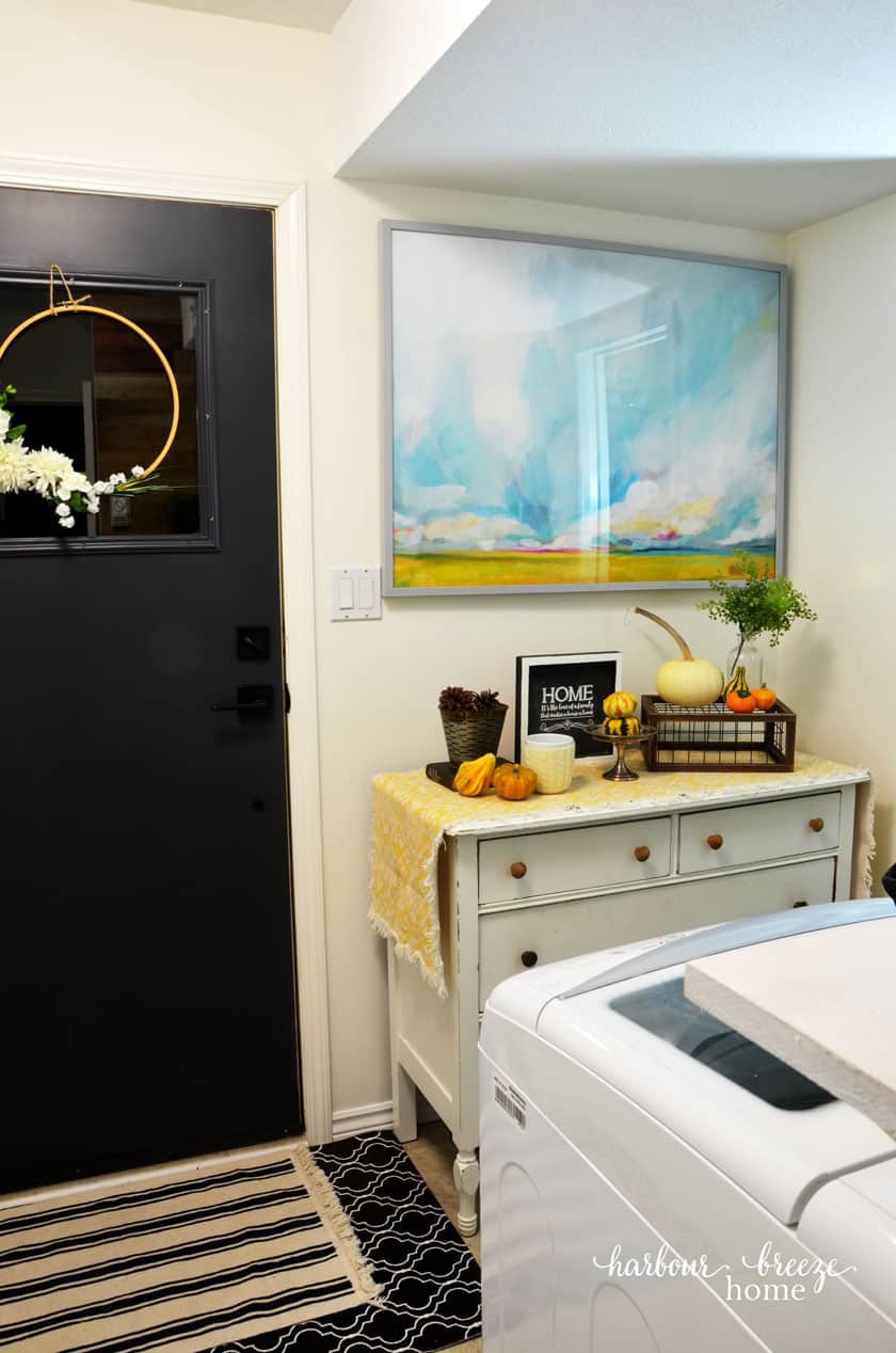 Back Entrance Door with White Dresser and Watercolor Art from Minted above it
