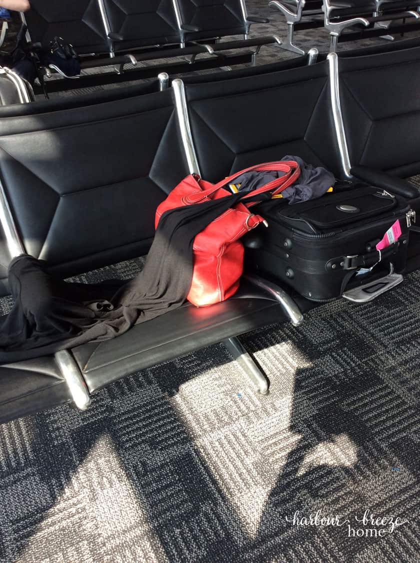 suitcase sitting on a seat in an airport