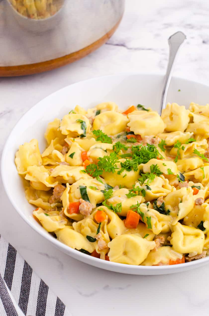 Bowl of creamy tortellini soup with spinach