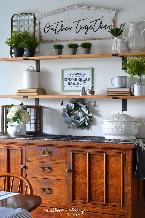 DIY Fixer Upper wall shelves decorated with farmhouse decor for Winter above a Dining Room buffet.
