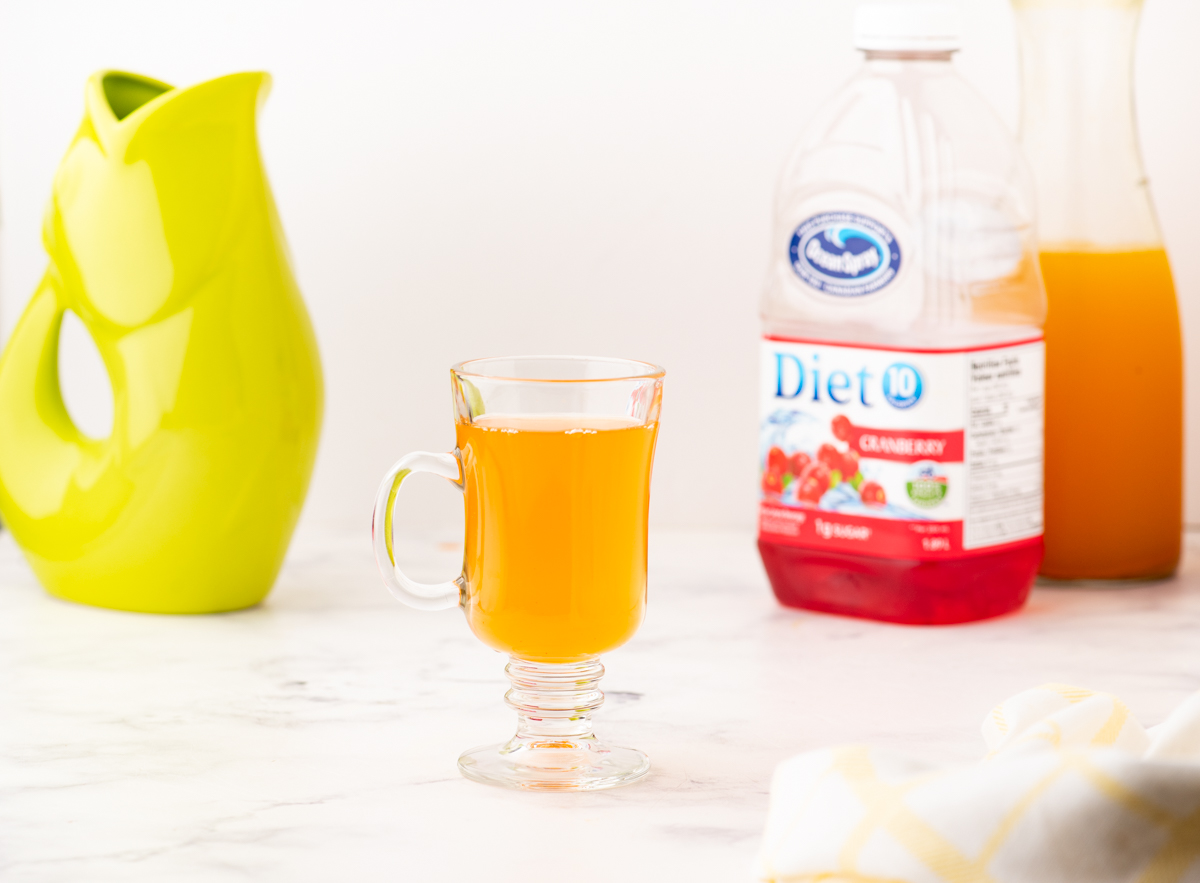 tumeric tea in a cup that has been topped up with water.
