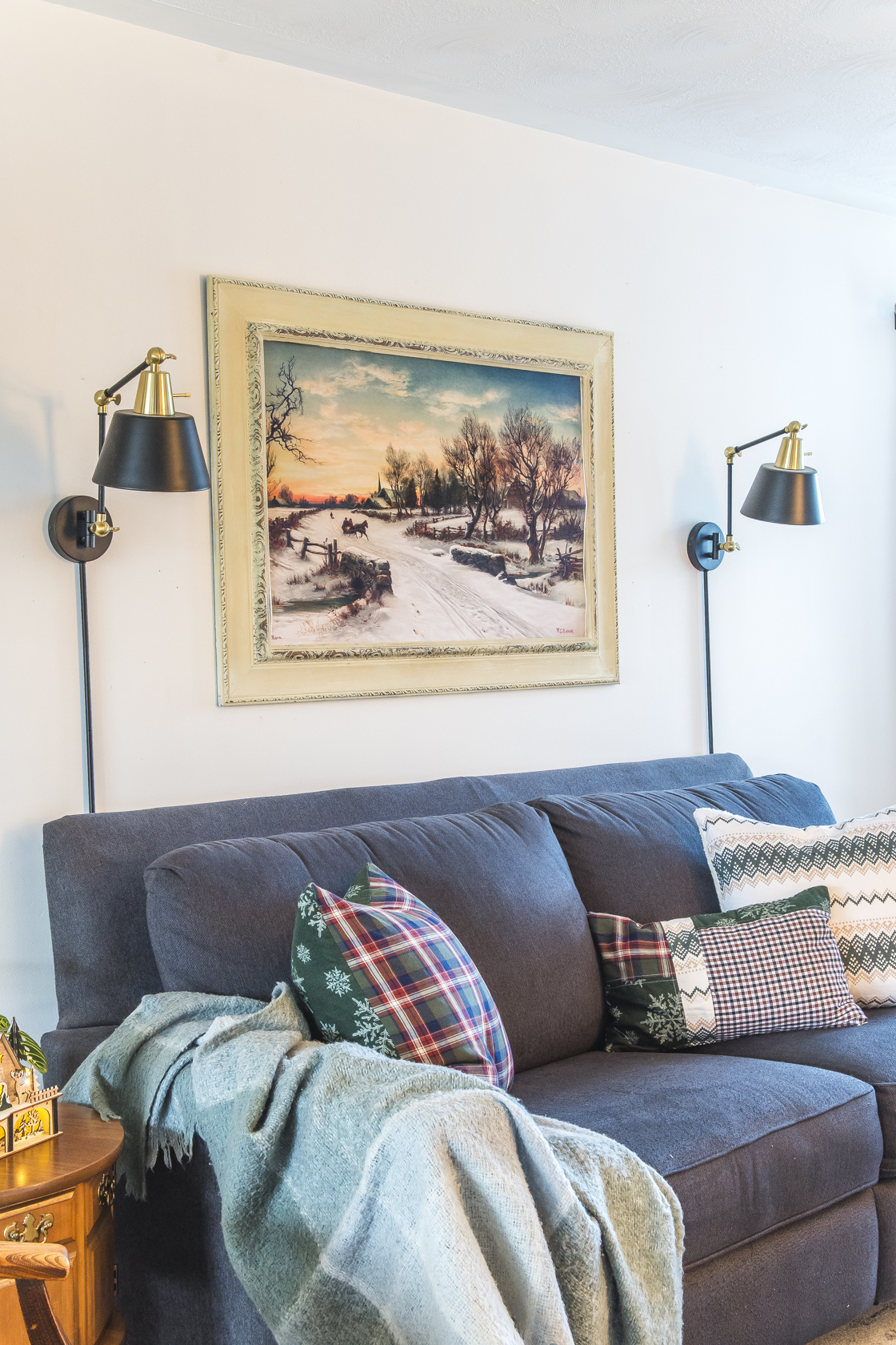 The Christmas Morn vintage wall art print hung above a couch.