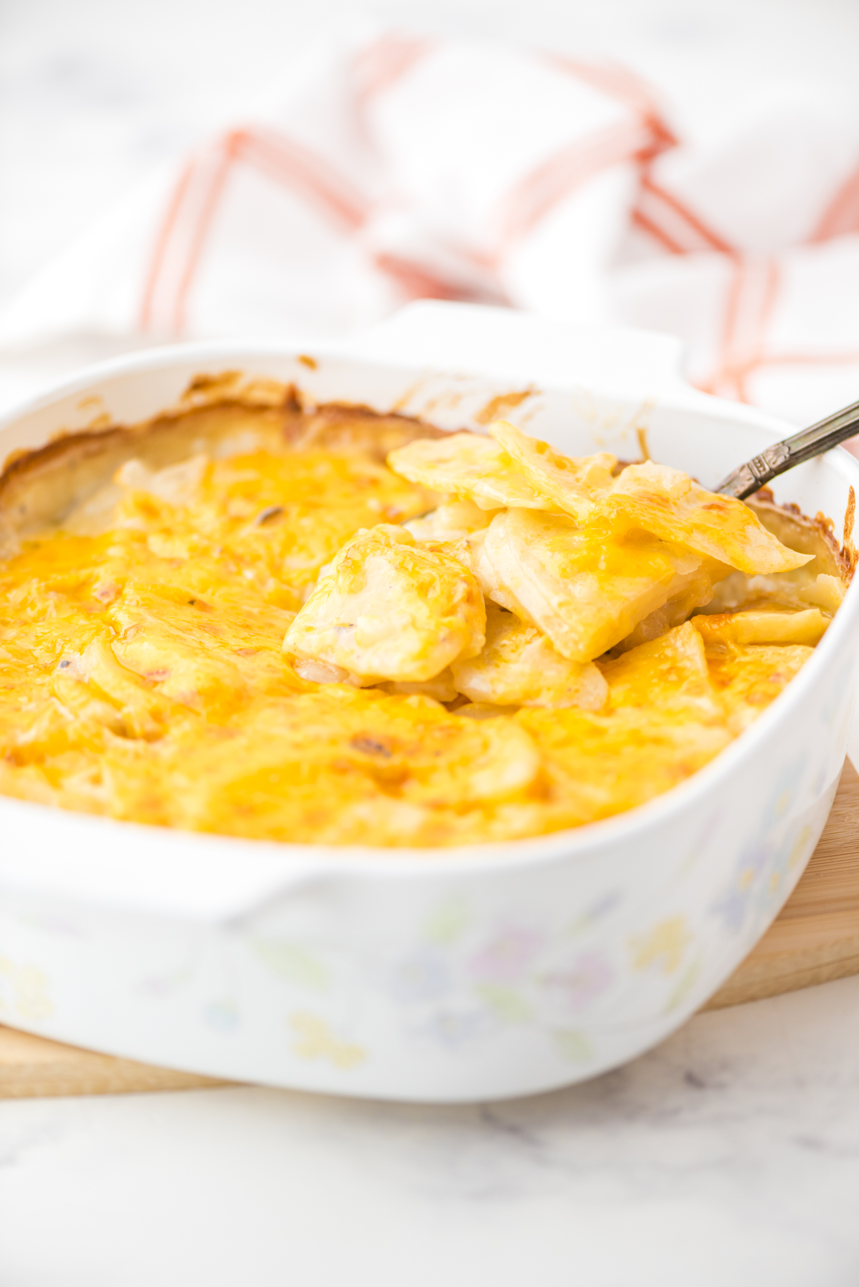 A casserole dish of cheesy scalloped potatoes with mushroom soup
