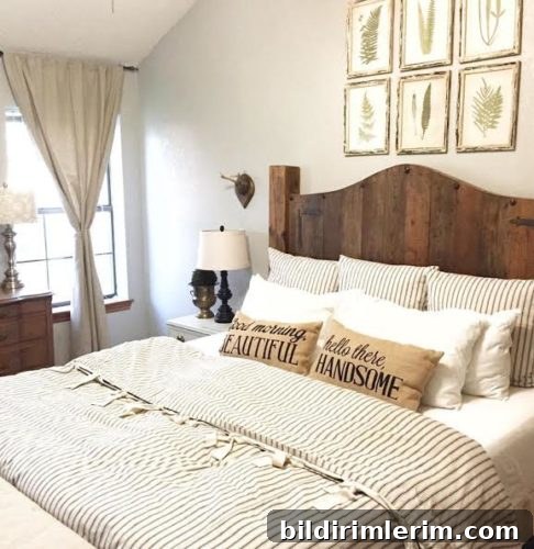 Stylish Modern Farmhouse Bedroom Ideas 3 Farmhouse bedroom with a bed with a wooden headboard; botanical art prints above the bed, and striped linen bedding and pillows.