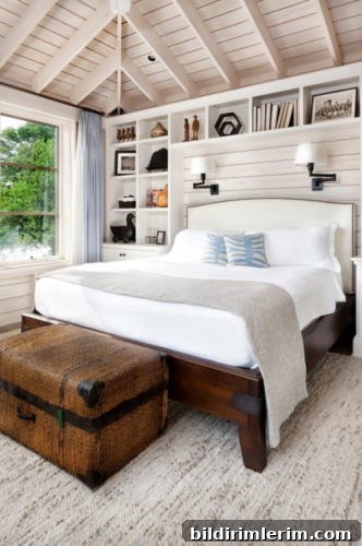 Stylish Modern Farmhouse Bedroom Ideas 5 A farmhouse bedroom with a floor to ceiling built in bookcase surrounding the bed with white headboard, wooden frame and white bedding.